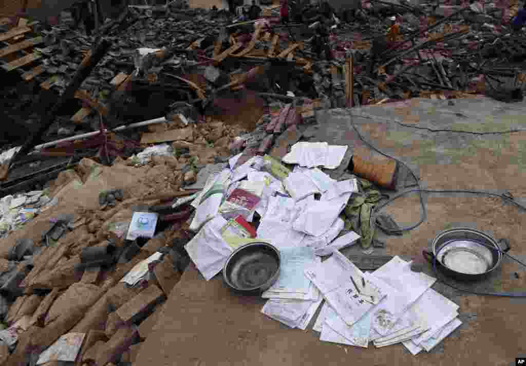 School text books lie on the rubbles after a masive earthquake in the town of Longtoushan in Ludian County, Aug. 5, 2014.