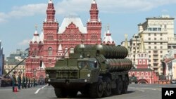 FILE - Russian S-400 air defense missile systems drive during the Victory Day military parade in Red Square in Moscow, Russia, May 9, 2016. 