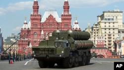 FILE - Russian S-400 air defense missile systems drive during the Victory Day military parade marking 71 years after the victory in WWII in Red Square in Moscow, Russia, May 9, 2016. 