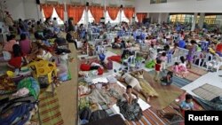 People take shelter from typhoon Hagupit in an evacuation center in Surigao city, southern Philippines, Dec. 5, 2014.