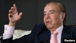 FILE - Former Argentine president Carlos Menem speaks during an interview with Reuters at his home in Buenos Aires, Oct. 6, 2009. 