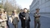 FILE - North Korean leader Kim Jong Un (C) visits the Kim Il Sung University in March 2014. Nobel Prize winners will visit the North's top universities to give speeches and hold workshops in May 2016.