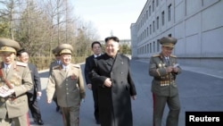 FILE - North Korean leader Kim Jong Un (C) visits the Kim Il Sung University in March 2014. Nobel Prize winners will visit the North's top universities to give speeches and hold workshops in May 2016.