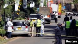Kenyan policemen and explosives experts gather evidence from the car suspected to have been used by the attackers outside the scene where explosions and gunshots were heard at the DusitD2 complex, in Nairobi, Kenya, Jan. 17, 2019. 