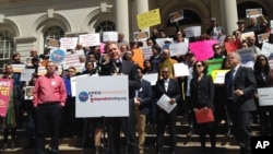 FILE - In this April 14, 2016, photo an activist speaks at a rally on the steps of New York's City Hall. As New York voters prepared for presidential primary elections, critics decried restrictive ballot rules that they say disenfranchise countless New Yorkers.