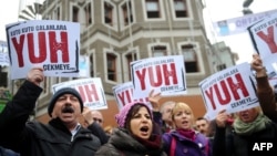 People hold placards reading "Shame to thieves with Boxes" during a demostration on Dec. 29, 2013, in Istanbul against corruption and the government.