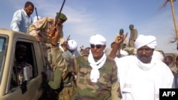 Musa Hilal (C), the leader of the Arab Mahamid tribe in Darfur, salutes his followers upon his arrival in Nyala, the capital of South Darfur state, Dec. 7, 2013.