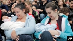 FILE - Mothers feed their babies in Paris, Oct. 11, 2008, during a worldwide breastfeeding event. 