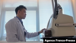 This photo taken on Nov. 5, 2021 shows Yang Kaiyuan (R), a cosmetic doctor at beauty clinic PhiSkin, checking equipment at the clinic in Shanghai.