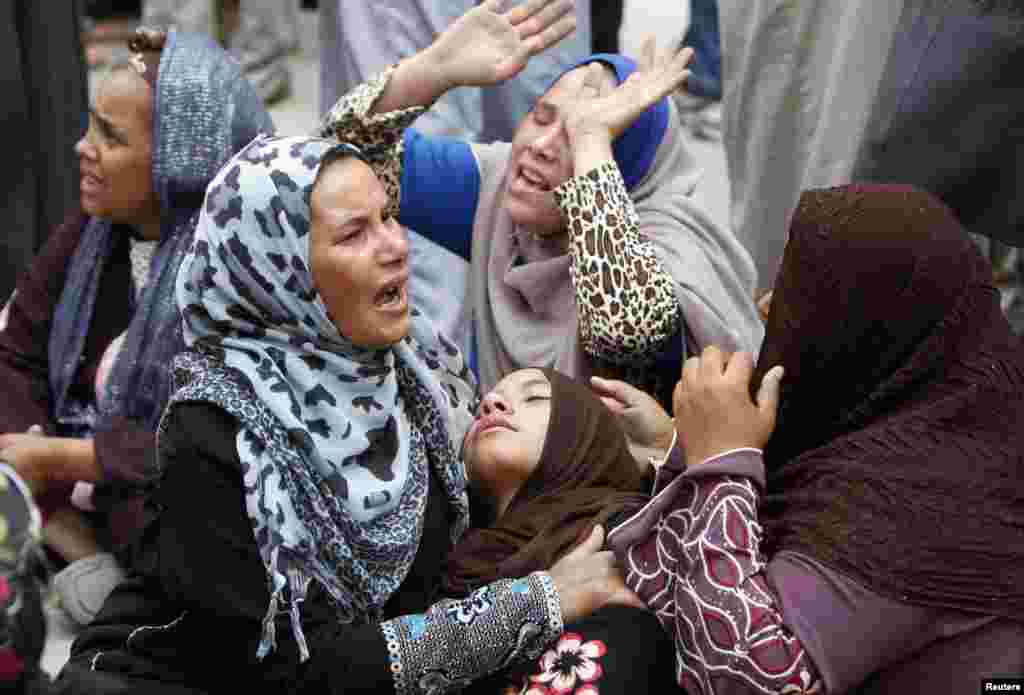 Relatives and families of members of Muslim Brotherhood and supporters of ousted President Mohamed Morsi react after hearing an Egyptian court has recommended the death sentence for the leader of the Muslim Brotherhood and 682 supporters, and handed down a final capital punishment ruling for 37 others, in front of the court in Minya, south of Cairo.