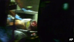 This still frame from video shows Boston Marathon bombing suspect Dzhokhar Tsarnaev visible through an ambulance after he was captured in Watertown, Massachusetts, Apr. 19, 2013.