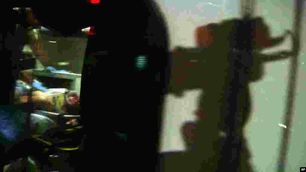 This still frame from video shows Boston Marathon bombing suspect Dzhokhar Tsarnaev visible through an ambulance after he was captured in Watertown, April 19, 2013.