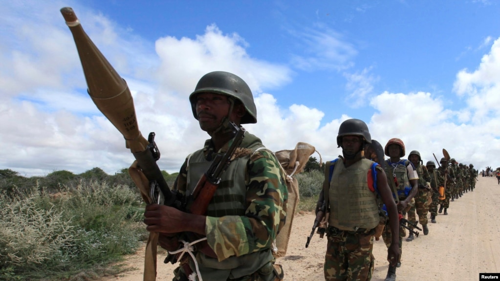 FILE - African Union Mission in Somalia (AMISOM) peacekeepers from Burundi patrol after fighting between insurgents and government soldiers on the outskirts of Mogadishu, May 22, 2012.