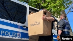 Polisi membawa kotak ke gedung polisi di Mainz, Jerman, 3 Mei 2023, setelah polisi Jerman menangkap puluhan orang di seluruh negeri dalam penyelidikan kelompok kejahatan terorganisir 'Ndrangheta Italia.. (REUTERS/Timm Reicher)