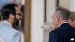 Senate Judiciary Committee Chairman Chuck Grassley, R-Iowa, right, speaks with Garrett Ventry, an adviser to the committee, left, on Capitol Hill, Sept. 19, 2018, in Washington. NBC News has reported that Ventry, who has been assisting in the committee's response to a sexual assault allegation against Supreme Court nominee Brett Kavanaugh, has "stepped down amid evidence he was fired from a previous political job in part because of a sexual harassment allegation against him." 