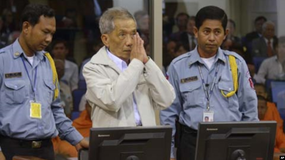 FILE - Former Khmer Rouge S-21 prison chief Duch (C) greets the court during his appeal hearing at the Court Room of the Extraordinary Chambers in the Courts of Cambodia (ECCC) on the outskirts of Phnom Penh, Feb. 3, 2012. 