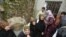 Relatives mourn Ikrama Abkour, whom activists say was killed in a Syrian Air Force missile attack, near Homs, Dec. 21, 2012.