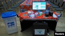 FILE - An electronic voting machine and a ballot box are seen inside the Congo's electoral commission (CENI) head offices at the Gombe Municipality in Kinshasa, Democratic Republic of the Congo, March 1, 2018.