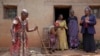 Prudencienne Namukobwa, 85, left, entertains her guests with akazehe, a Burundian traditional form of musical greeting performed exclusively by women, outside her house in Ngozi, Burundi, Sept. 20, 2024. 