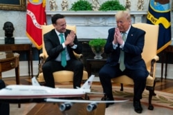 President Donald Trump and Irish Prime Minister Leo Varadkar joke about not shaking hands during a meeting in the Oval Office of the White House, March 12, 2020.