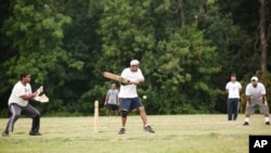 A batsman takes a swing during a cricket match between the Titans and the Blitzkrieg Crickets of the Washington Metro Cricket League.