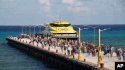 Tourists and passengers disembark from a ferry at Playa del Carmen, Mexico, March 2, 2018. Undetonated explosives were found on another ferry that runs between the Caribbean resorts of Playa del Carmen and the island of Cozumel, authorities said, less than two weeks after a blast shook another ferry plying the same route.