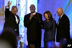 Bishop John Drew Sheard, center left, leads a congregation in a prayer over Democratic presidential nominee Vice President Kamala Harris during a church service at Greater Emmanuel Institutional Church of God in Christ, Nov. 3, 2024, in Detroit, Michigan.