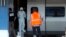 People wait for a train in the foreground as members of a police forensics team take part in an investigation next to a Thalys train on the platform at Arras train station, northern France, Aug. 22, 2015. 