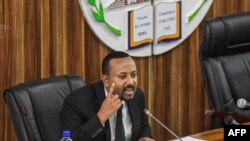 FILE - Ethiopia's Prime Minister Abiy Ahmed addresses the parliament in Addis Ababa, July 1, 2019. Ahmed's government has dropped charges against Israeli businessman Menashe Levy, who had been in prison since 2015. Levy has since been released.
