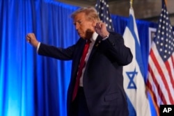 Republican presidential nominee former President Donald Trump leaves an event marking one year since the Oct. 7 Hamas attack on Israel, Oct. 7, 2024, in Miami.