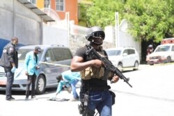 FILE - Members of the Haitian police and forensics look for evidence outside of the presidential residence in Port-au-Prince, Haiti, July 7, 2021.