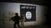 FILE - In this March 1, 2017 photo, an Iraqi soldier inspects a tunnel, adorned with an Islamic State group flag. 