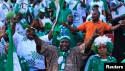 Supporters of Nigeria's football team celebrate their 2 - 1 victory over Ethiopia in their 2014 World Cup qualifying match.