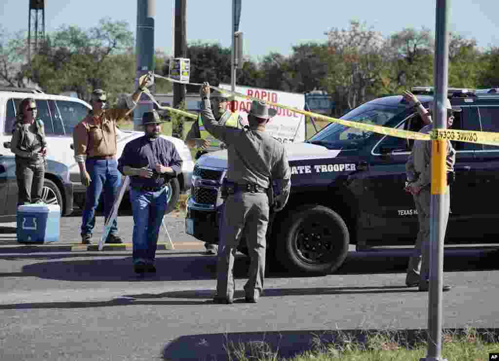 Law enforcement officers man a barricade near the First Baptist Church of Sutherland Springs after a fatal shooting, Nov. 5, 2017, in Sutherland Springs, Texas.