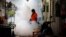 A city worker fumigates the area to control the spread of mosquitoes at a university in Bangkok, Thailand, Sept. 13, 2016. 