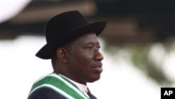 Nigeria President Goodluck Jonathan watches Nigeria troops parade during his inauguration ceremony at the main parade ground in Nigeria's capital of Abuja, May 29, 2011