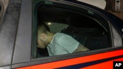 American teenager Finnegan Lee Elder, who was allegedly questioned in the case of a slain Carabinieri policeman, is seen on a Carabinieri car as it leaves a police station, in Rome, Italy, July 27, 2019.