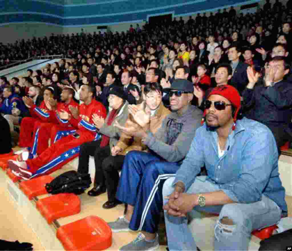 This image released by the Korean Central News Agency (KCNA) and distributed by the Korea News Service, former NBA star Dennis Rodman, second right in front row, visits a dolphin aquarium in Pyongyang in North Korea Friday, March 1, 2013.