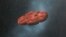 This 2018 illustration provided by William Hartmann and Michael Belton shows a depiction of the Oumuamua interstellar object as a pancake-shaped disk. A study published in March 2021 says the mystery object is likely a remnant of a Pluto-like world and shaped like a cookie. 