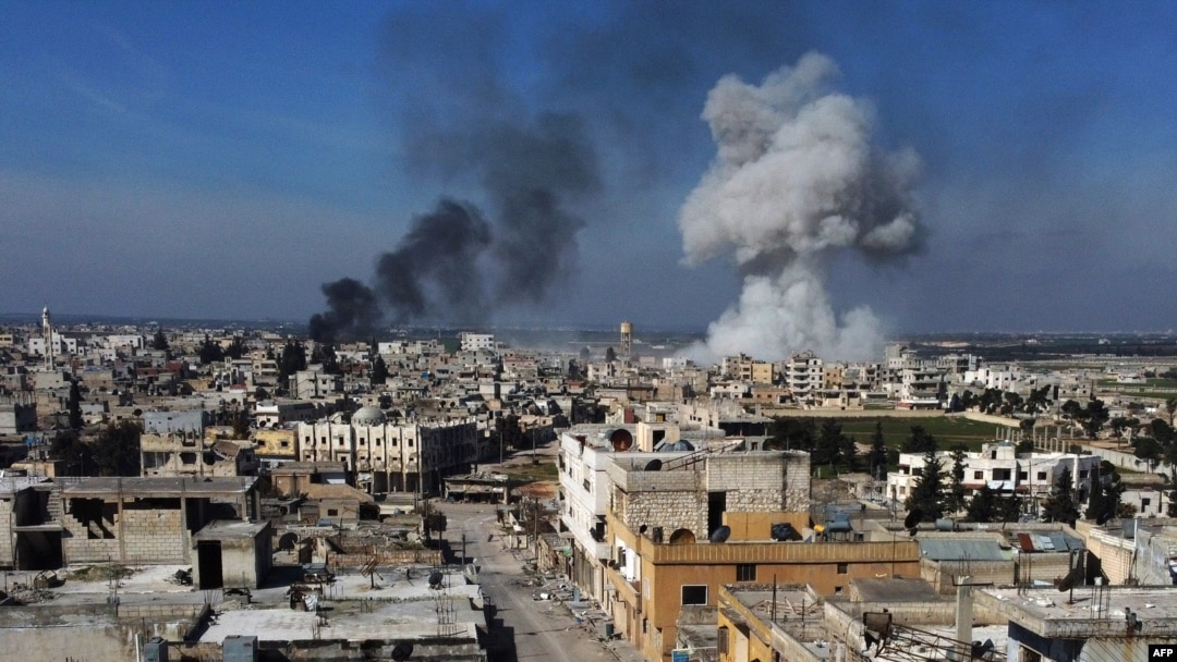Smoke billows over the town of Saraqib in the eastern part of the Idlib province in northwestern Syria, following bombardment by Syrian government forces, on February 27, 2020-