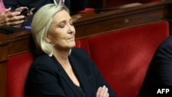 President of Rassemblement National parliamentary group Marine Le Pen reacts during the debate prior to the no-confidence votes on Prime Minister Michel Barnier's administration at the National Assembly in Paris on Dec. 4, 2024.