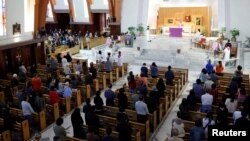 FILE - Catholics attend Mass at a church in Taipei, Taiwan, March 11, 2018. 