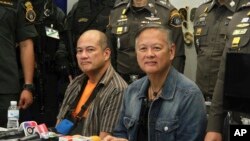 Ex-municipal mayor, Mario Reyes, left, and former Gov. Joel Reyes of western Palawan island province attend a press conference at Crime Suppression Division in Bangkok, Thailand, Monday, Sept. 21, 2015.