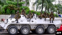 Bangladesh army personnel stand guard during a curfew following clashes between police and Anti-Discrimination Student Movement activists amid anti-government protests in the Shahbag area of Dhaka on August 5, 2024.