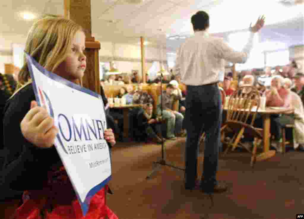 Supporters listen to Republican presidential candidate, former Massachusetts Gov. Mitt Romney as he speaks during a campaign stop at Homer's Deli and Bakery in Clinton, Iowa, Wednesday, Dec. 28, 2011. (AP Photo/Chris Carlson)