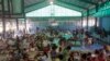 FILE - Residents rest in an evacuation center at suburban Quezon city northeast of Manila, Philippines after fleeing their homes in anticipation of typhoon Hagupit, Dec. 9, 2014.