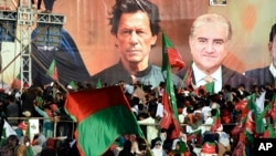 Supporters of Pakistan's jailed former Prime Minister Imran Khan (pictured, top-center) rally, demanding his release from prison where he has been held for more than a year after being sentenced in multiple cases, on the outskirts of Islamabad, Pakistan, Sept. 8, 2024.