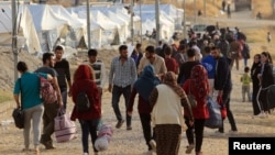 شام کی سرحد پر لڑائیوں سے بے گھر ہونے والے افراد عراق کے ایک کیمپ میں پناہ لینے کے لیے آ رہے ہیں۔ 