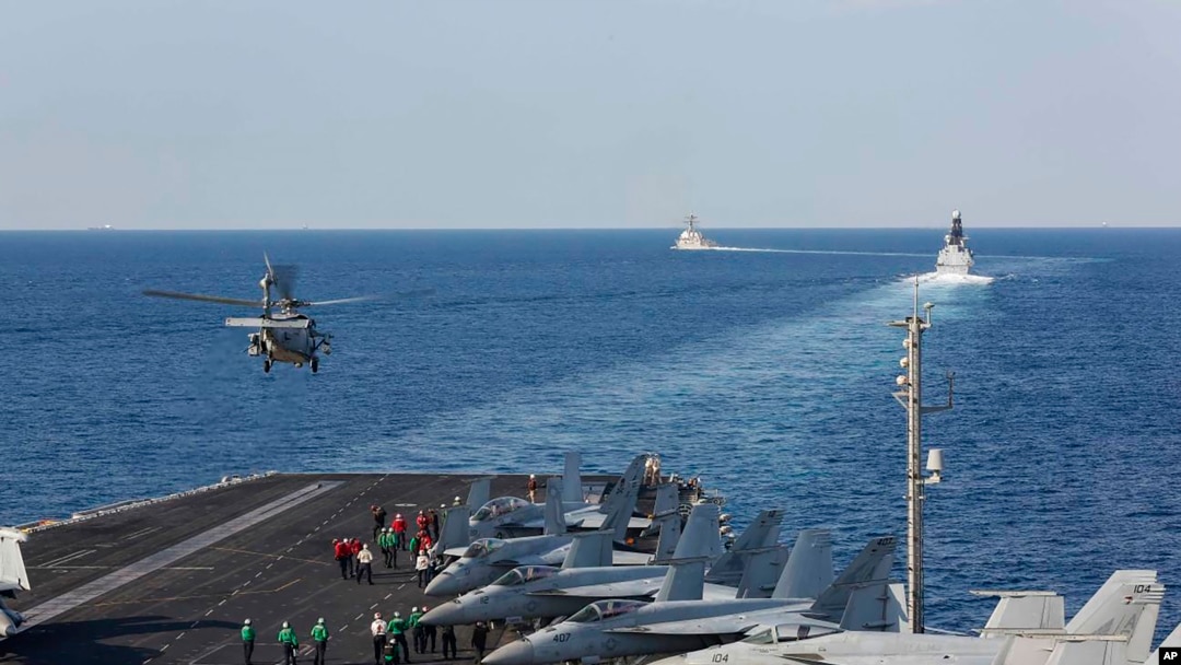 FILE - In this Nov. 19, 2019, photo, made available by the U.S. Navy, a helicopter lifts off from the aircraft carrier USS Abraham Lincoln as it transits the Strait of Hormuz. 