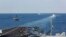 FILE - In this Nov. 19, 2019, photo, made available by the U.S. Navy, a helicopter lifts off from the aircraft carrier USS Abraham Lincoln as it transits the Strait of Hormuz. 